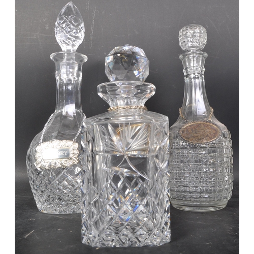 716 - A collection of 19th and 20th century cut glass decanters to include acid etched examples,ships and ... 