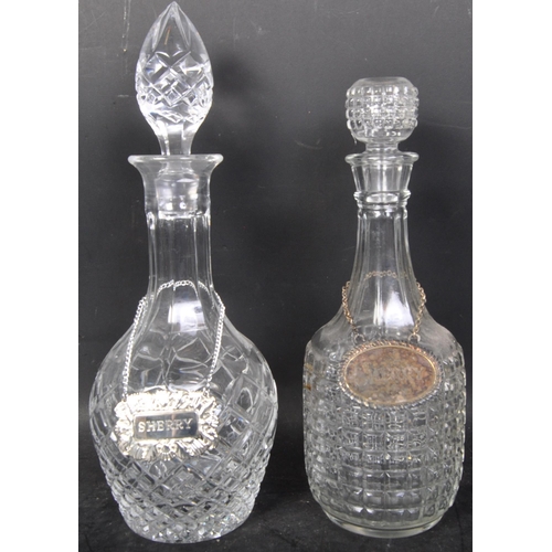 716 - A collection of 19th and 20th century cut glass decanters to include acid etched examples,ships and ... 