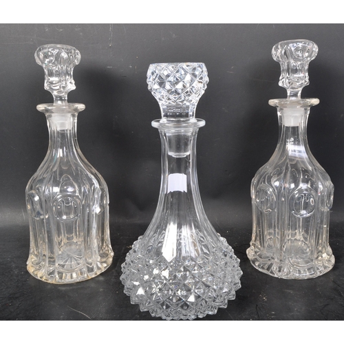 716 - A collection of 19th and 20th century cut glass decanters to include acid etched examples,ships and ... 