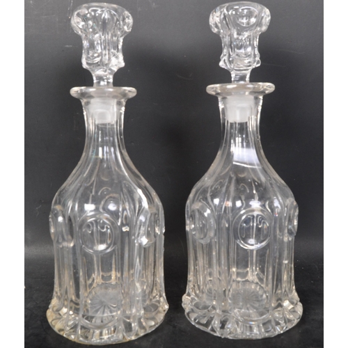 716 - A collection of 19th and 20th century cut glass decanters to include acid etched examples,ships and ... 