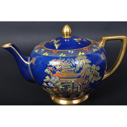 719 - Carlton Ware - A vintage 20th century Carlton ware teapot. The teapot having a cobalt ground with gi... 