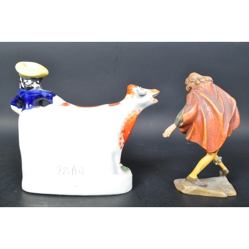 725a - A 19th Century Staffordshire figurine of cow and milk maid. Measures approx. Together with a wooden ... 