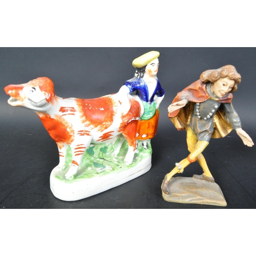 725a - A 19th Century Staffordshire figurine of cow and milk maid. Measures approx. Together with a wooden ... 