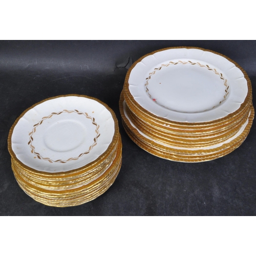 747 - A Bristol Pottery early 20th century porcelain dinner service with cream ground and gilded colourway... 