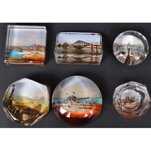 766 - A collection of vintage 20th Century glass tourist place paperweights. To include, Forth bridge, Lla... 