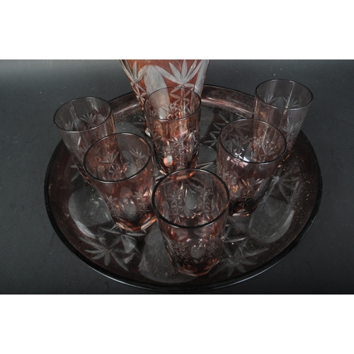 769 - A 20th Century cranberry glass decanter tray and drinking glasses. Having a pink and clear colourway... 