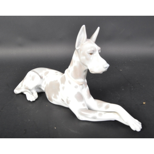 770 - Lladro - Spanish hand made porcelain - A figurine statue of a Great Dane dog in the lying down posit... 