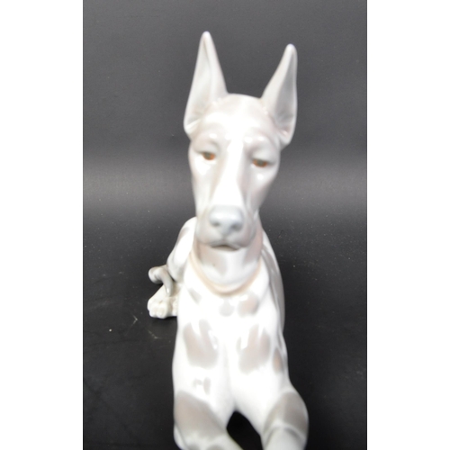 770 - Lladro - Spanish hand made porcelain - A figurine statue of a Great Dane dog in the lying down posit... 