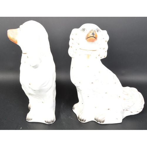 784 - A pair of vintage 20th Century ceramic fire side mantel Staffordshire spaniel dogs. Having gilt colo... 