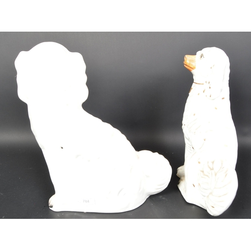 784 - A pair of vintage 20th Century ceramic fire side mantel Staffordshire spaniel dogs. Having gilt colo... 