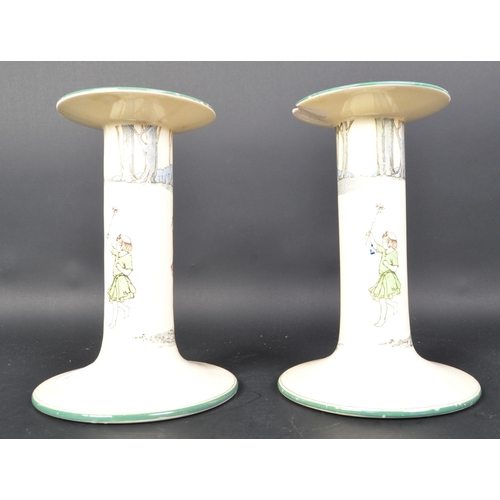 786 - A pair of Royal Doulton series ware ceramic large candle stick holders. (af) Having a lipped top, ha... 