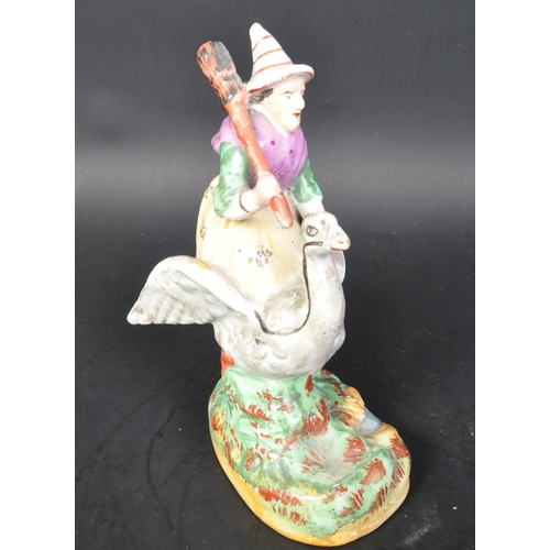 788 - A vintage 19th Century Staffordshire ceramic mother goose statue figurine. Holding a broom riding a ... 