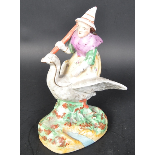 788 - A vintage 19th Century Staffordshire ceramic mother goose statue figurine. Holding a broom riding a ... 