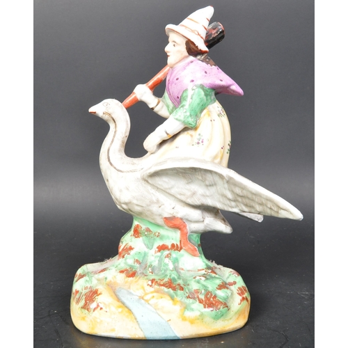 788 - A vintage 19th Century Staffordshire ceramic mother goose statue figurine. Holding a broom riding a ... 