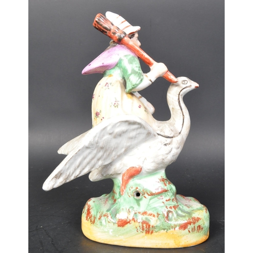 788 - A vintage 19th Century Staffordshire ceramic mother goose statue figurine. Holding a broom riding a ... 