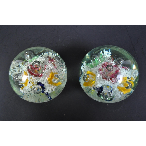 791 - A pair of Victorian 19th century Nailsea glass paperweight dumps with polychrome floral decoration w... 