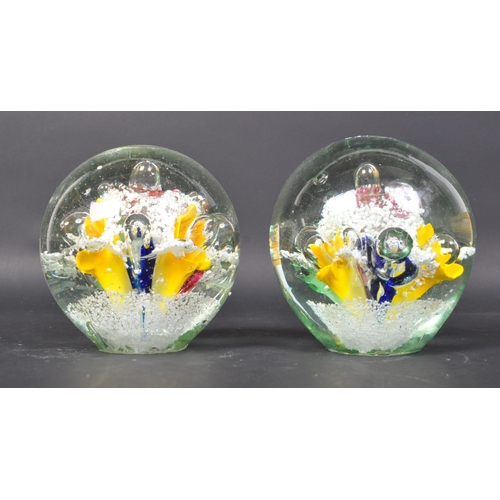 791 - A pair of Victorian 19th century Nailsea glass paperweight dumps with polychrome floral decoration w... 