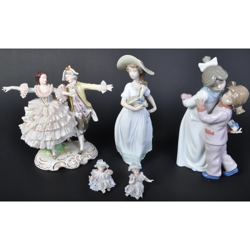 707 - An assortment of 20th century Dresden German porcelain lace figurines comprising of a couple dancing... 