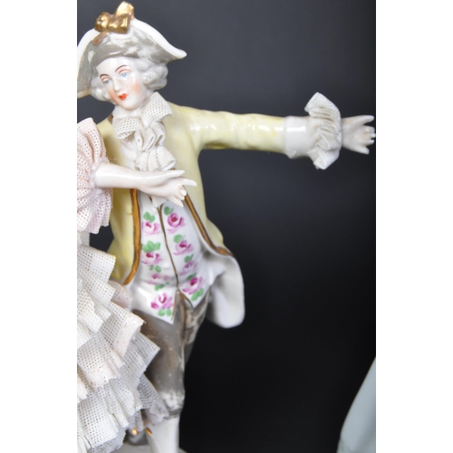 707 - An assortment of 20th century Dresden German porcelain lace figurines comprising of a couple dancing... 