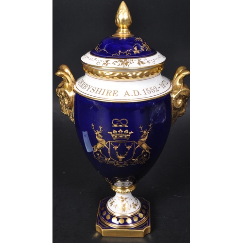 710 - A Coalport Porcelain ' Chatsworth ' Vase and Cover being of ovoid form with rams head handles and ac... 