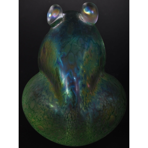 712 - A vintage 20th century John Ditchfield for Glasform iridescent glass frog shaped paperweight in a gr... 