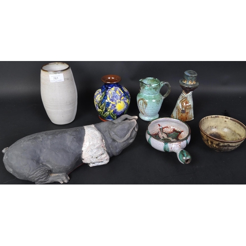 761 - A collection of studio art pottery to include; a Rakn pottery model of a saddleback. Pig signed by L... 