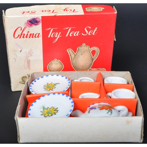 692 - A retro vintage mid 20th Century toy child's china tea service set. With teapot, two saucers and cup... 