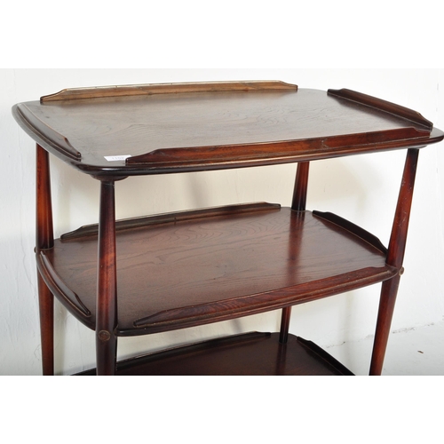 1152 - An Ercol vintage retro 20th Century dark elm wood tiered serving trolley. Of rectangular form with g... 