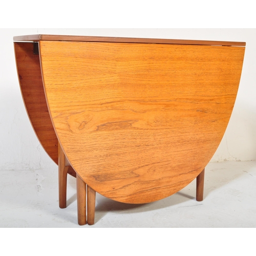 1157 - A retro vintage 20th century teak wood dining suite. The lot to include a teak wood drop leaf dining... 