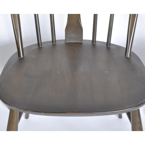 1159 - A vintage mid 20th Century Ercol Old Colonial dining suite. Comprising of a dining table with slot i... 