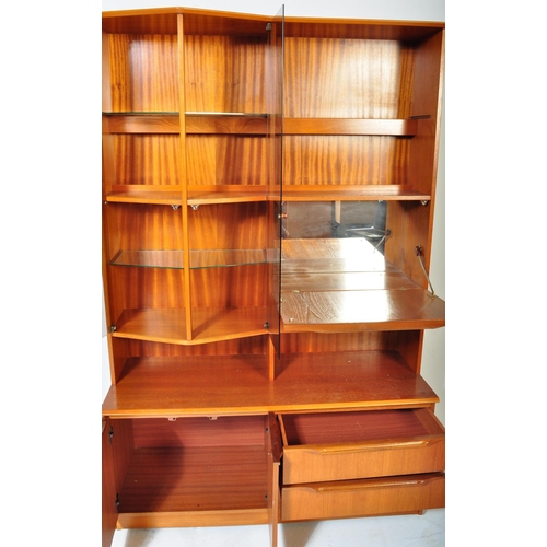 1162 - A retro vintage 20th century teak wood display cabinet / wall unit having a straight top over a glaz... 