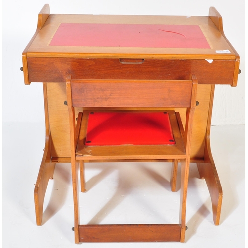 1163 - A retro vintage 20th century teak wood children school desk with matching chair. The table having a ... 