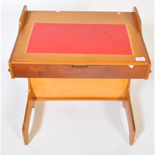 1163 - A retro vintage 20th century teak wood children school desk with matching chair. The table having a ... 