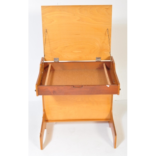 1163 - A retro vintage 20th century teak wood children school desk with matching chair. The table having a ... 