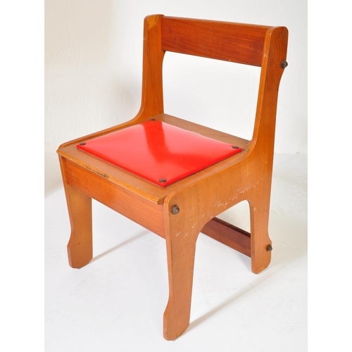 1163 - A retro vintage 20th century teak wood children school desk with matching chair. The table having a ... 