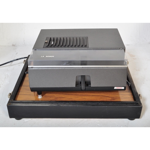 1166 - A mid 20th Century oak wood projector case being hand made with sectional top enclosing a Hanimex au... 