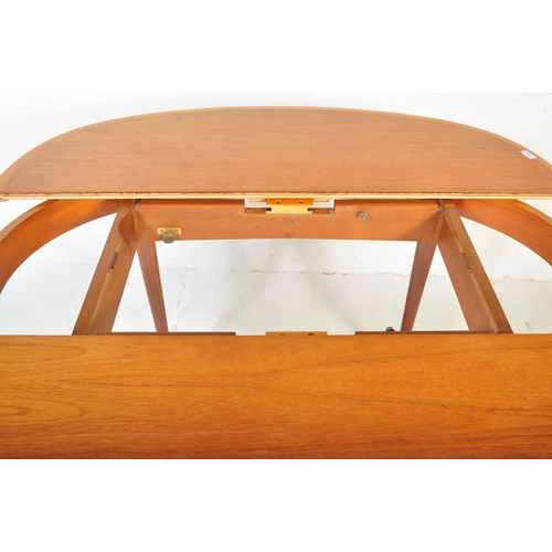 1167 - A retro vintage mid 20th Century teak wood dining table raised on tapering legs with oval extending ... 