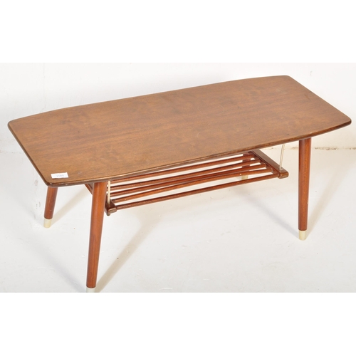 1185 - A vintage retro mid 20th century teak surfboard coffee table having a shaped top with rail under tie... 