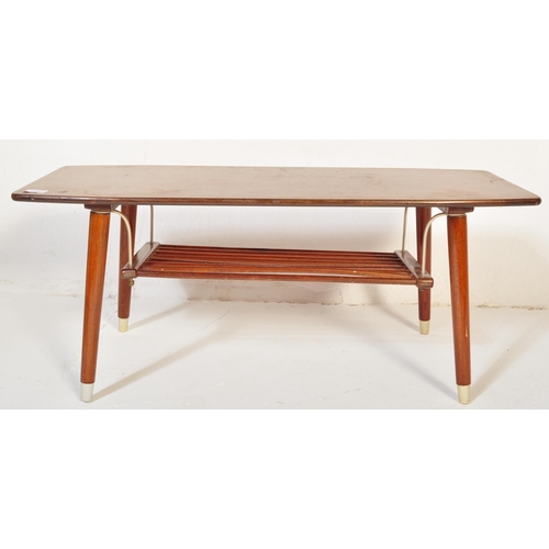 1185 - A vintage retro mid 20th century teak surfboard coffee table having a shaped top with rail under tie... 