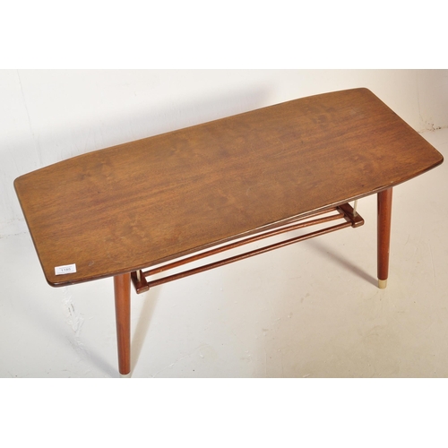 1185 - A vintage retro mid 20th century teak surfboard coffee table having a shaped top with rail under tie... 