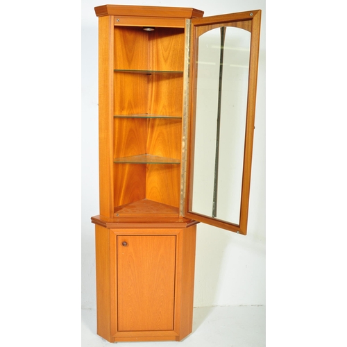 1186 - A vintage retro mid 20th teak upright corner cabinet having pediment over a single glazed door openi... 