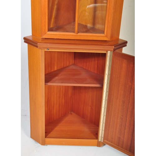 1186 - A vintage retro mid 20th teak upright corner cabinet having pediment over a single glazed door openi... 