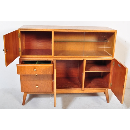 1191 - Beautility - A vintage retro mid 20th century teak sideboard. The sideboard having a glazed sliding ... 