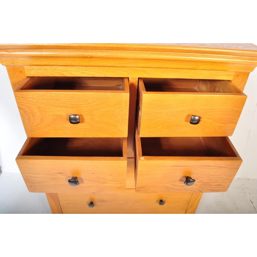 1200 - A Contemporary modernist chunky oak furniture land chest of drawers. Raised on a plinth base with sh... 