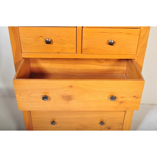 1200 - A Contemporary modernist chunky oak furniture land chest of drawers. Raised on a plinth base with sh... 