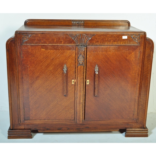 1202 - A vintage 20th century oak Art Deco era circa. 1930's sideboard having carved palmette type motifs w... 