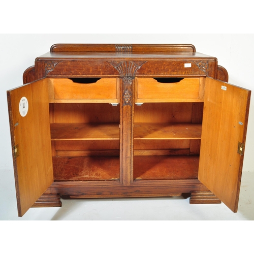 1202 - A vintage 20th century oak Art Deco era circa. 1930's sideboard having carved palmette type motifs w... 