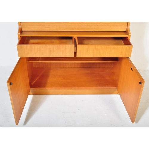 1204 - A retro vintage mid 20th century, circa 1970s Danish inspired teak wood bureau desk. Raised on taper... 