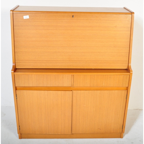 1204 - A retro vintage mid 20th century, circa 1970s Danish inspired teak wood bureau desk. Raised on taper... 