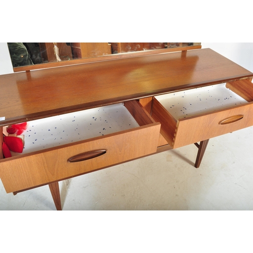 1205 - A Mid century teak wood Dressing table in the manner of Frank Guille for Austinsuite. Raised on tape... 